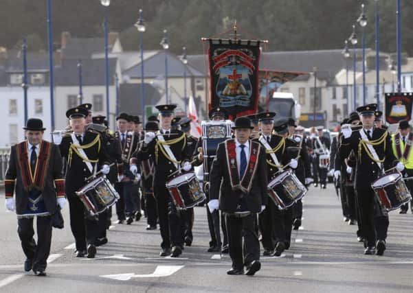 Members of the Royal Black Preceptory parade across Craigavon Bridge on Saturday morning. LS36-114KM
