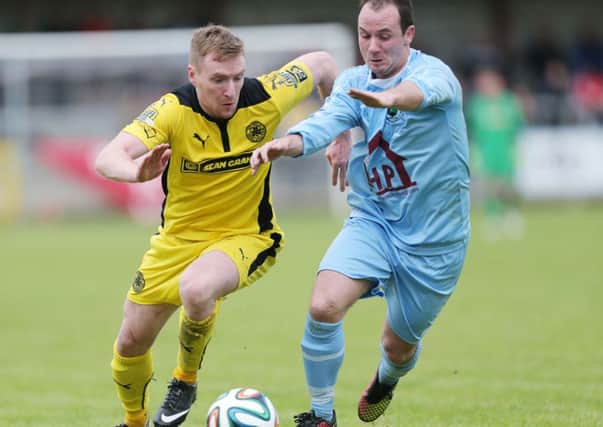 Cliftonville winger Chris Curran tries to get away from Institutes Declan McKeever, during Saturdays match the Riverside Stadium.