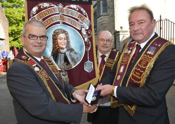 Robin Logan, right, Past President of the Baker Parent Club, pictured handing over a 40 years service jewel to Victor Wray, left. Included is Alwyn Ferguson. INLS3214-114KM