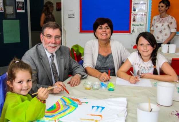 Social Development Minister Nelson McClausland and Lynda Wilson, Director of Barnardo's NI, joinging in the fun with Erin and Colleen. INNT 35-502-SO