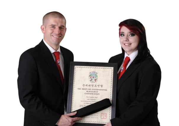 Leah Harbinson (18) has been training in Taekwondo for 5 years in total.
This was awarded by a council of the highest ranking instructors in the UK.
Leah trains twice a week Monday 7-8 and Thursday 7-8 in Brownlow Rec.
She is pictured with Kevin McCourt Chairman for Northern Ireland Taekwondo.