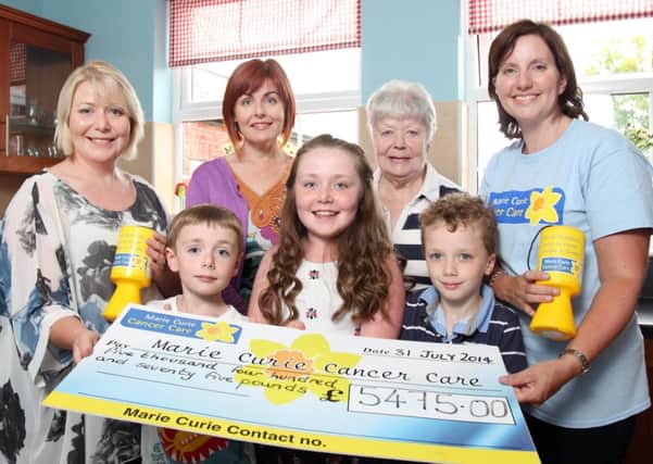 At the cheque presentation were Pauls sister Mary (Magee) Kennedy, his wife Helen, his mother, Kathleen, councillor Yvonne Craig and representative of Marie Curie Cancer Care. Also included werePauls children Jack (8) and Holly (10) Magee and Malachy Kennedy (8). US1432-501cd  Picture: Cliff Donaldson