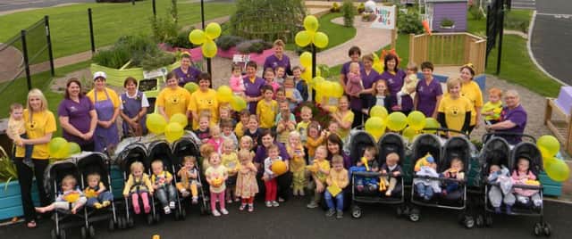 Staff and children from Happy Days Community Childcare pictured at their recent Sunshine Yellow Day in aid of Marie Curie Cancer Care. INBM35-14
