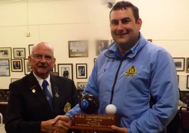 William Barron (N.I.B.A. President) presents the 'George Richardson Bowl' to Philip Cromie, the president of Lisnagarvey, winners of the N.I.B.A. Championships Top Club Competition.