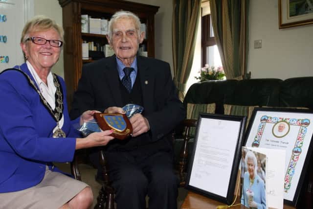 Mayor of Ballymena, Cllr. Audrey Wales, is pictured with Mr. John McLarnon celebrating his 100th birthday. Mr. McLarnon is also pictured with his card from Queen, blessing from the Pope and a letter from the Irish President Mr. Michael D. Higgins. INBT35-201AC
