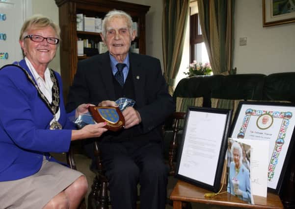 Mayor of Ballymena, Cllr. Audrey Wales, is pictured with Mr. John McLarnon celebrating his 100th birthday. Mr. McLarnon is also pictured with his card from Queen, blessing from the Pope and a letter from the Irish President Mr. Michael D. Higgins. INBT35-201AC
