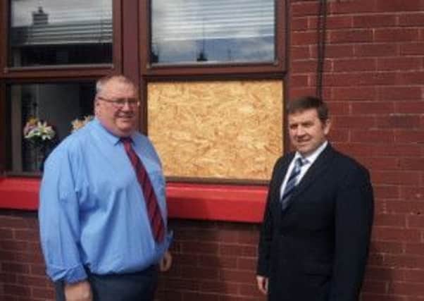 Ballymena UUP Councillor Stephen Nicholl and North Antrim UUP MLA Robin Swann pictured outside a local Housing Executive property awaiting repairs.