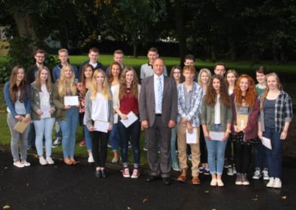 Pictured with Principal Mr Patrick Allen are the 22 pupils from Foyle College who received nine or more grade As in their GCSE examinations.