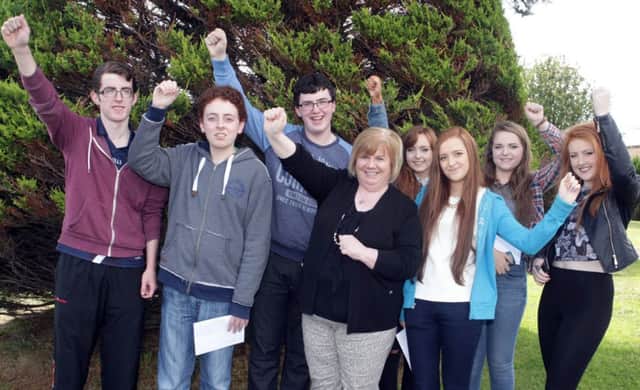 Yessssssss.  Cross & Passion Principal Barbara Ward, pictued with pupils who celebrated their GCSE results on Thursday. They are, Liam Fletcher, Torai Watson, Oliwia Sankiewicz, Conleth Burns, Niamh Brogan, Anna Duncan and Paul McVeigh.INBM35-14 009SC.
