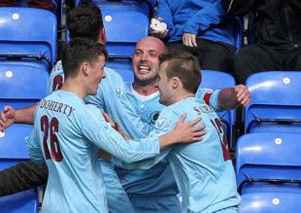 Institute skipper Paddy McLaughlin is mobbed after scoring the equaliser against Linfield during Saturday's match at the Riverside Stadium. Picture by Brian Little/Presseye