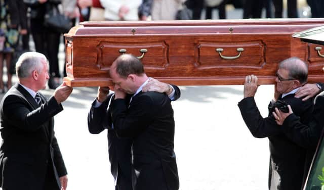 The remains of Gerry Anderson are carried into St. Eugenes Cathedral for funeral Mass.  DER 3414-0415MT.