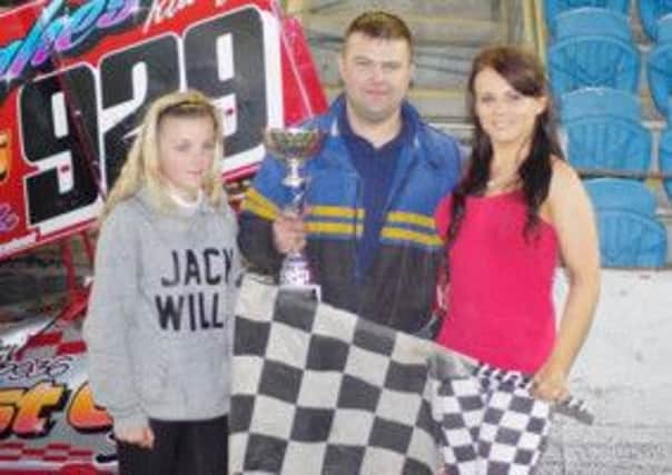 F2 Stock Car Supreme Champion Conor Hughes and his daughter Leah collect the trophy from Haley Bevan. Picture: Davy Park.