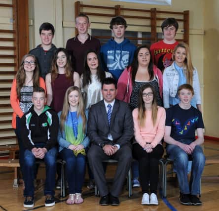 Mr McCullough Principal of the Rainey Endowed School Magherafelt surrounded by students who obtained 6A*/A Grades at GCSE level.INMM3514-322
