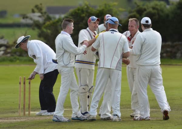 The Bonds Glen players celebrate after taking an early Sion Mills wicket on Saturday. INLS3414-140KM