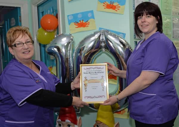 Owner of Willowbank Daycare Nursery, Barbara McVeigh (left) presents a certificate of achievement for 10 years service to Rose Marie McAllister. INLT 36-020-PSB
