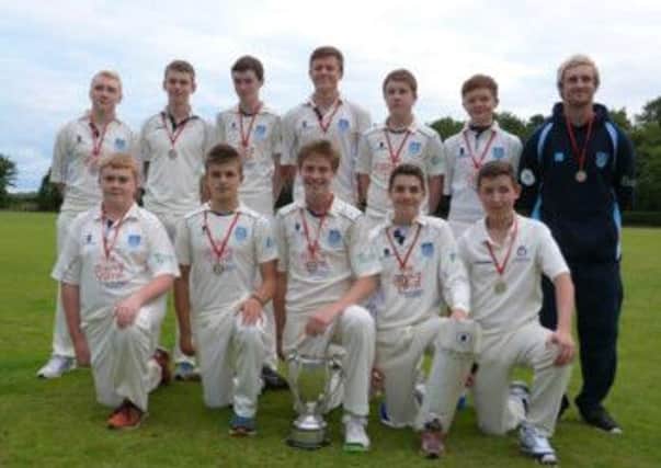 Carrick's Under 15 league winning team and coach Jamie Holmes with the trophy.  INLT 35-690-CON