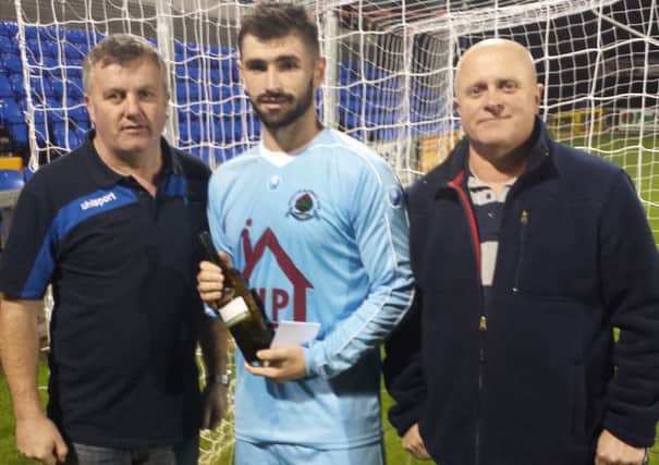 Institute's Cormac Burke picked up the Institute Supporters man of the match award, after their game against Dollingstown. Also pictured are Ian Culbert and Paul Lewis.
