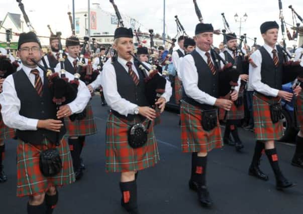 Tullylagan Pipe Band with Pipe Major Robert Black (left) pictured on parade through the packed streets following the North West Pipe Band Championships at Portrush on Saturday 23rd August.