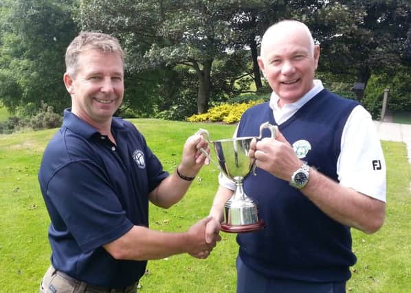 Gents Captain Paul Banford presenting Jimmy Robinson with the Seniors Club Championship trophy.