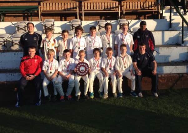 Derriaghy CC Under 13 NCU Division 2 winners and their coaches with the Queensway Shield.