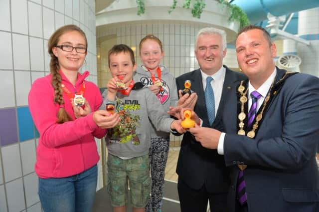 Duck Derby winners (l-r) Jodie Davis (2nd), Jack Moriarty (1st) and Olivia Loughran (3rd) are pictured with Councillor Alan Carlisle, Vice-Chair of the Council's Leisure Services Committee and the Mayor of Lisburn, Councillor Andrew Ewing.