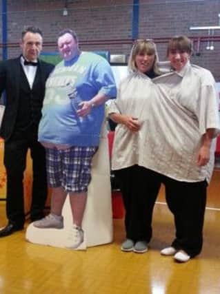 Kells and Connor Slimming World Group guest speaker Thomas McIntyre with 'before weight loss' life size pic with (right) Group members Sarah Woods and Allison Loudon - (group nominees for Woman of the Year) who both fitted into one of Thomas' former shirts.