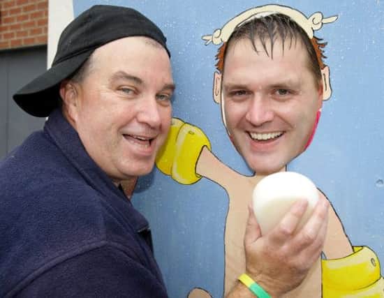 John Porter gives Pastor Darren McWilliams a soaking on the Aunt Sally stand at Lisburn City Elim church family fun day. US1434-501cd  Picture: Cliff Donaldson