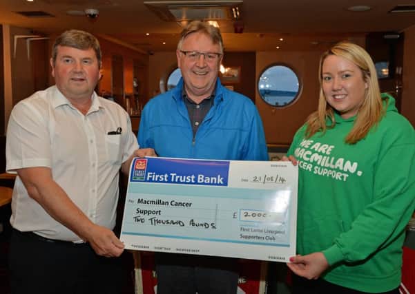 Chris Dears, general manager of Multi Packaging Solutions, and Johnny Dowds from First Larne Liverpool Supporters Club present a cheque for £2,000 to Emma Ewings, Fundraising Manager with Macmillan Cancer Support.