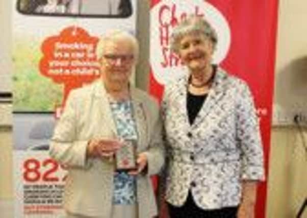 Anne McDowell from Carrickfergus receives a Volunteer Award for more than 30 years of dedicated service from Northern Ireland Chest Heart & Strokes Governance Board member Ann Hayes. INCT 36-709-CON
