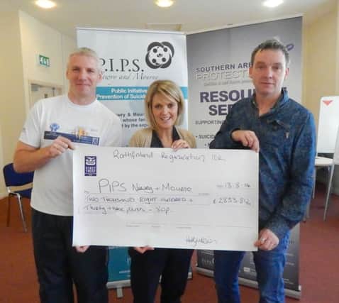 Kathy Wilson from the Rathfriland Regeneration Group handing over the cheque to Kevin Gallagher and Eamon Murphy from PIPS Newry & Mourne.