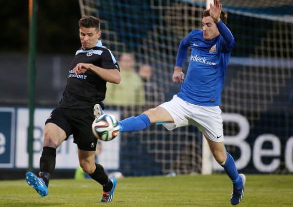 Ballymena United defender Mark McCullagh clears the danger from Glenavon's Andy McGrory during Friday night's match at Mourneview Park. Picture: Press Eye.