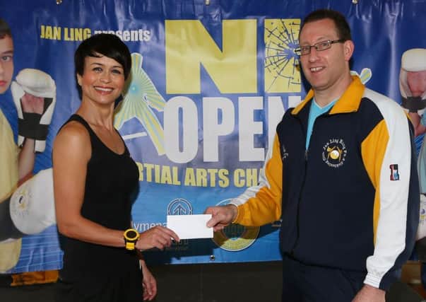 Estelle Wallace of Shrink Fitness presents a sponsorship cheque to Ernie Johnston of Ballymena Jan Ling Club for the International Martial Arts team event, featuring teams from England, Scotland, Republic of Ireland and Northern Ireland, which will be held in Ballymena North in September 6. INBT 25-174CS