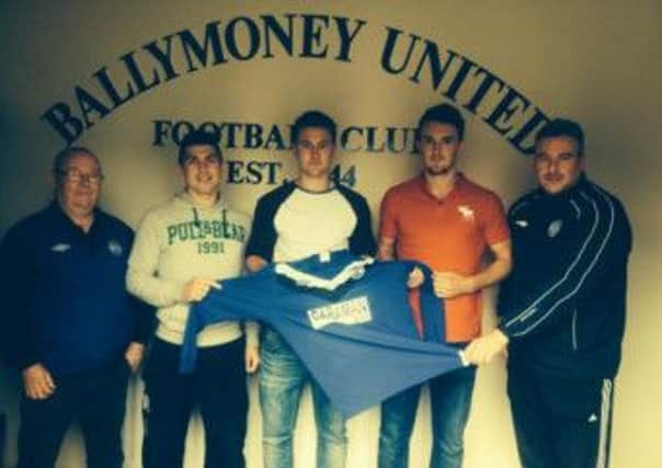 Ballymoney United manager Chris Peacock, right, welcomes new signings Conor McKinley, Nigel Elliot and Shane Jennings.
