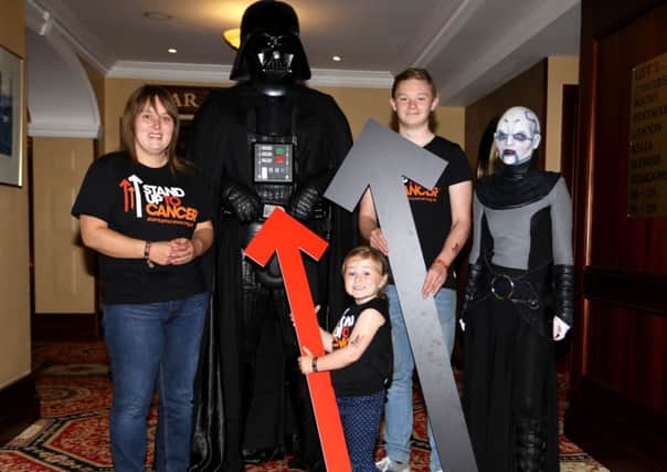 Young Ellie May with her Mum Kelly McConnell and Adrian McConell, along with Darth Vader and Ventres of the Emerald Guard, promoting the forthcoming Stand Up To Cancer telethon. INBT36-208AC