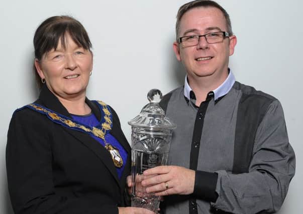Hugh McKenna receives a presentation from Magherafelt Council chairperson during a reception, hosted by the chairperson in recognition of the success of the McKenna School of Dance at the 2014 World Championships.