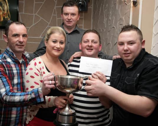 FAMILY WINNERS. Leanne McMaster and David Baker, pictured at the Ballymoney & Coleraine Snooker League presentation night at the Scenic Inn on Thursday night presenting the Baker Family Doubles trophy to winners, Geoffrey Boreland and Curtis Boreland.INBM16-14 016SC.