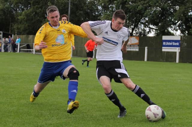 Rathfriland Rangers winger Thomas Lockhart beats defender Scott Cully to deliver a cross into the Markethill Swifts box. Photo: Iain McDowell/Rathfriland FC