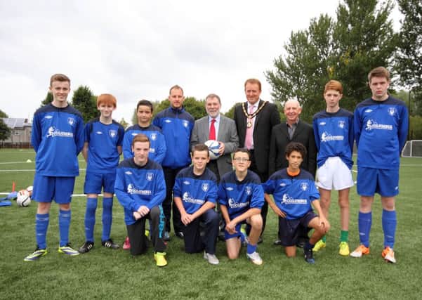 DSD Minister Nelson McCausland (back row, centre) and the Mayor of Craigavon Councillor Colin McCusker with Craigavon City officials and youth players at Drumgor. Pics by Noel Quinn.INLM35-868