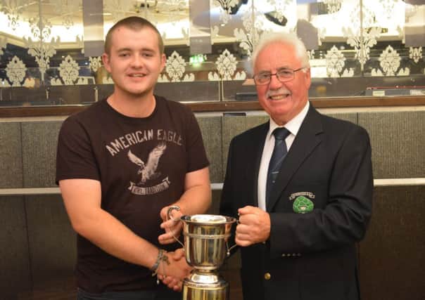 Matthew Madden (left) collects the Silverwood Cup from club captain Frank Gallagher.INLM36-165
