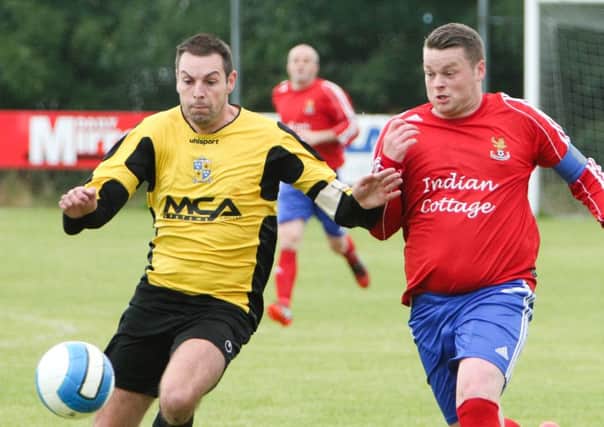 Islandmagee captain Michael Moore (right) challenges for the ball in the cup match against Comber Rec. Photo: Ronnie Moore.