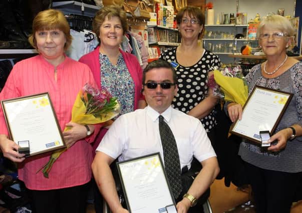 Carol McKigney (Assistant Manager) and Lynda McKeown (Manager) from the Marie Curie Shop, who presented Syliva McCullough, Philip Patton and Anne Balmer with Bronze Awards for 5 years volunteering service in the local shop. INBT37-211AC