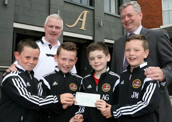 Eugene McKeever of the Adair Arms Hotel is pictured presenting a sponsorship cheque to Carniny Youth members Kieran McQuillan, Joe Murray, Anthony Greer and Leon Graham and coach Billy O'Flaherty. INBT37-204AC