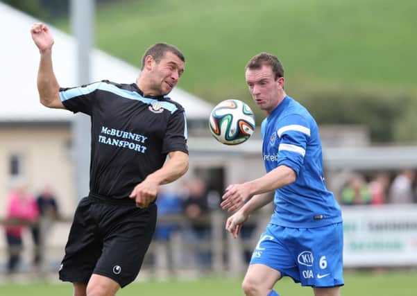 Ballymena United's Matthew Tipton competes for a loose ball with David Kee of Ballinamallard during today's Danske Bank Premiership match at Ferney Park. Picture: Press Eye.