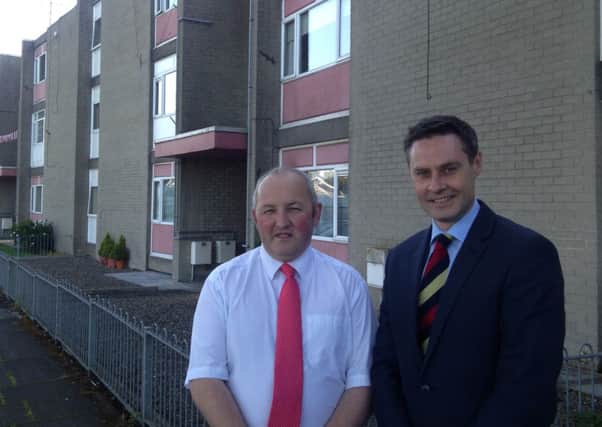Local Councillor Reuben Glover and MLA  Paul Frew are delighted by news of replacement roofs at Barra Drive, Ballykeel 1.