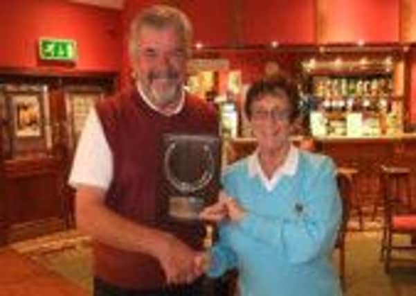The President, John Parkes, congratulates the Lady President, Glennis Smyth, on the ladies victory in the Horseshoe.