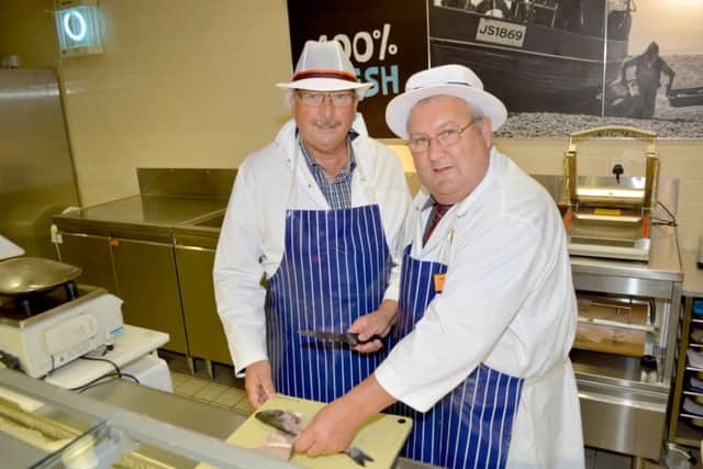 East Antrim MP Sammy Wilson being shown the ropes behind the fish counter in Sainsbury's Carrickfergus. INCT 37-126-GR