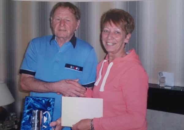 Veronica McDonnell from Larne and District Ladies Darts League presenting a tankard to Jimmy Baxter on his retirement from the league.  INLT 37-675-CON