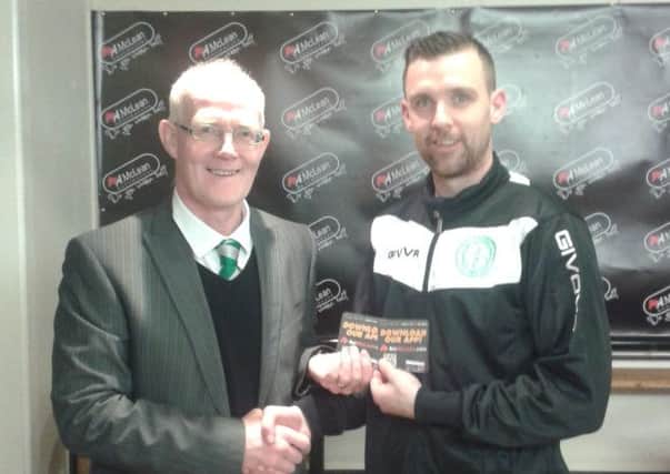 Raymond Fitzpatrick collects his McLean's Bookmakers-sponsored 'man-of-the-match' award from Paul O'Hara.INLM37-108