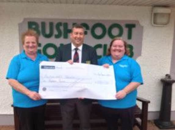 Presentation to Alzheimer's Society from proceeds from Captains Charity Bunker at Bushfoot Golf Club. Left to Right; Rosemary Neely (Volunteer, Alzheimer's Society) Kenny Gault, Captain 2013/14, Sharon Neely (Lead Volunteer Alzheimer's Society) (S)