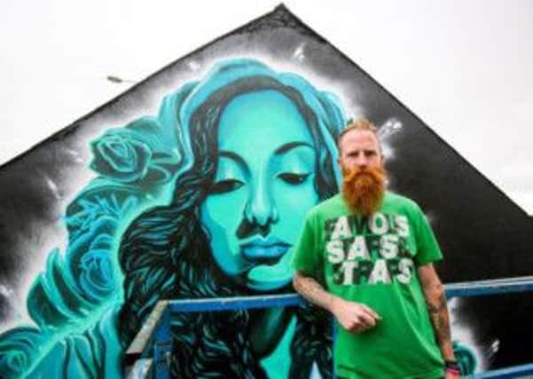 Dermot McConaghy in front of his new mural for PIPS entitled 'Hope'.